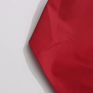 Close-up of red ruffled fabric texture with matte finish for luxury party evening top