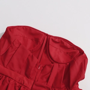 Detailed macro view of the pleated red satin bodice with built-in pads and hidden zipper