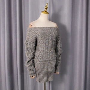 Detail of grey cable knit texture and off-shoulder design on short knitted dress