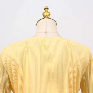 Detail view of light yellow pleated knit cardigan featuring delicate vertical textures