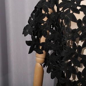 Détail macro de la dentelle florale noire ajourée sur un haut d'été de style moderne