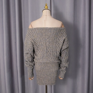 Detailed cable knit pattern on off-shoulder blue-grey knitted dress with ribbed cuffs