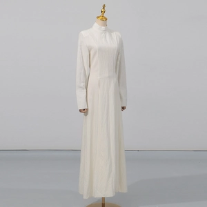 Detail of high stand collar and pleated texture on an elegant cream-white long dress