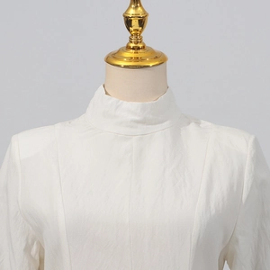 Detail of the elegant white stand collar with natural wrinkled texture on a slim dress