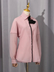 Pink casual women's shirt featuring lantern sleeves, black bow detail and pleated texture