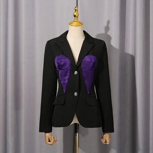 Detail of slim-fit black blazer featuring a unique purple satin corset patchwork design