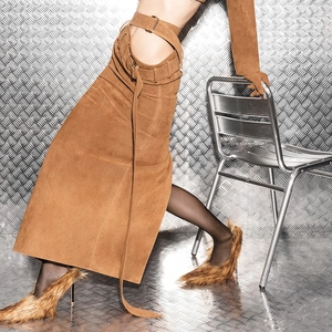 Detail view of brown faux suede skirt with hollow waist design and silver metal buckle belt