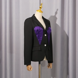 Detail of tailored black blazer with purple satin patchwork and sparkling rhinestone buttons