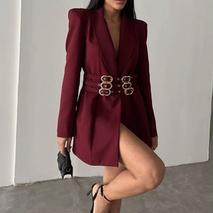 Close-up of wine red blazer dress featuring triple gold ring belts and padded shoulders