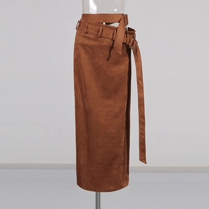 Detail of caramel suede midi skirt featuring double waistbands and metal buckles