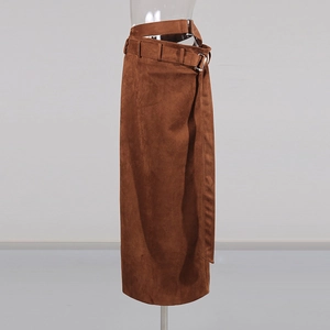 Detail of dark brown suede wrap skirt featuring a matching belt and silver metal buckle