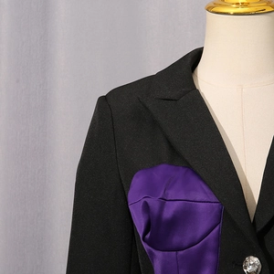 Detail of black blazer with purple satin patchwork and sparkling crystal rhinestone button