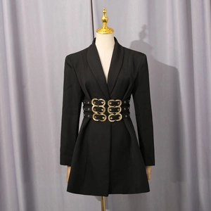 Detail of waist belts with golden embossed metal buckles on a black tailored blazer dress