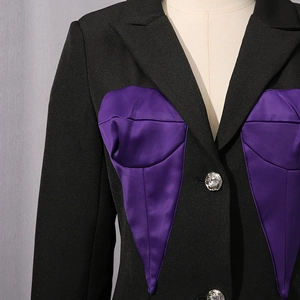 Detailed shot of blazer with purple satin peaked accents and silver carved button