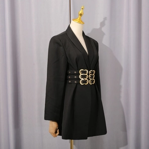 Detailed close-up of three parallel gold buckle belts on a black structured blazer dress
