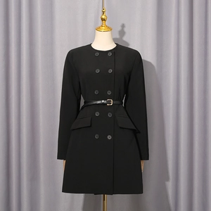 Detail of black double-breasted dress showing golden buckle belt and flap pockets