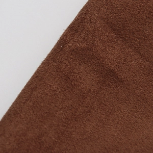 Macro detail of high-quality brown suede fabric texture on high-waist maxi skirt
