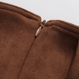 Detail of high-quality brown suede fabric with a seamless matching invisible zipper
