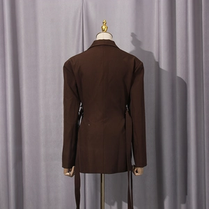 Detail of dark brown blazer back featuring adjustable waist ribbons and slim fit cut