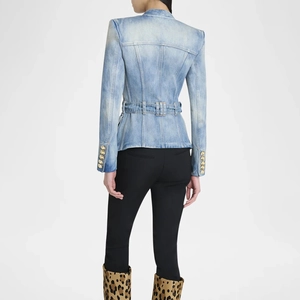 Detail view of denim jacket with tailored waist, waist belt, and gold buttons on cuffs