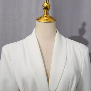 Detail of elegant white blazer with a shawl collar design on a mannequin display