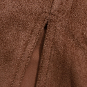 Detail of reinforced double stitching and slit on brown suede high waist skirt