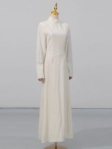 Elegant white long-sleeve maxi dress with side slit and sophisticated slim fit silhouette
