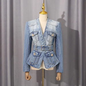 Detail of light blue denim peplum jacket with waist belt and gold metallic buttons