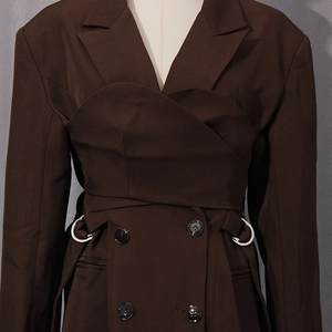 Detailed view of dark brown blazer featuring a wrap waist and silver metal ring buckle