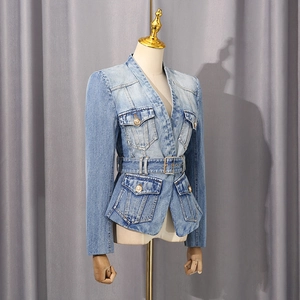 Detail of light blue denim blazer with waist belt and vintage gold lion head buttons