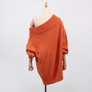 Detailed back view of an oversized orange off-shoulder knitted sweater on a mannequin
