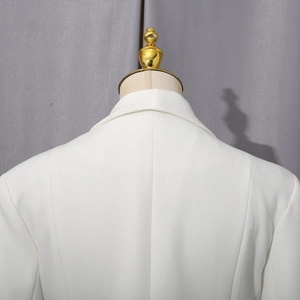 Detailed back view of a white slim-fit blazer showing precise seams and fabric texture
