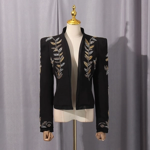 Detail view of intricate gold and silver sequin leaf embroidery on black blazer lapels
