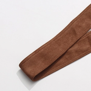 Close-up of brown suede skirt belt detail with premium stitching on a white background