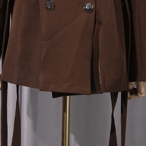 Detail of dark brown double-breasted blazer showing twill fabric texture and buttons