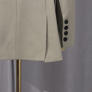 Detail of khaki blazer sleeve buttons and back slit tailoring for a slim fit look