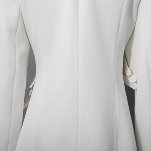 Close-up of premium white blazer featuring high-density twill fabric and slim waist tailoring