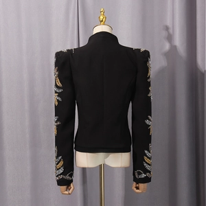 Close-up of golden leaf sequin embroidery on black slim-fit blazer sleeve