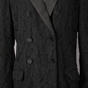 Close-up of black floral lace blazer with satin lapels and double-breasted buttons