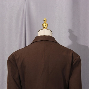 Detail view of the back of a dark brown professional blazer with structured tailoring
