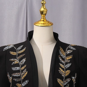 Detail of elegant black blazer with exquisite gold and silver sequin leaf embroidery