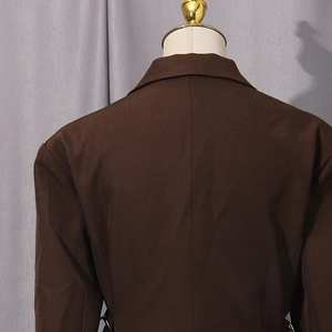 Detail view of the back and notched lapel of a slim fit dark brown business blazer
