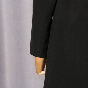 Close-up of the elegant black blazer sleeve showing high-quality stitching and fabric