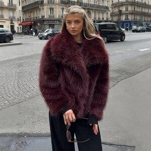 Close-up of burgundy long-hair faux fur jacket with large lapels and glossy texture