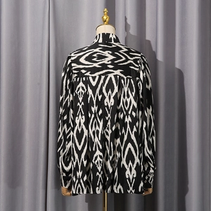 Detailed back view of a loose-fit long sleeve shirt with black and white abstract patterns