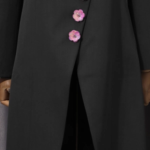 Detail of pink floral embroidery and sequins on black tailored blazer lapel