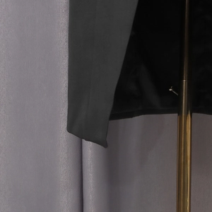 Detail shot of premium black woven fabric showing high-density texture and fine stitching