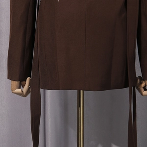 Detailed macro view of the dark brown blazer hem with matching tie belt on a mannequin