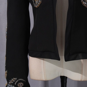 Detailed view of intricate floral beadwork and sequins on a black slim fit blazer