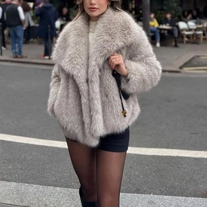 Detail of premium faux fur texture and wide lapel collar on light gray winter coat